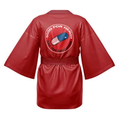 The Kaneda Bike Decals Akira Happi Coat Haori Kimono features a red kimono-style design with wide sleeves, a belt, and a capsule pill graphic on the back with "GOOD FOR HEALTH, BAD FOR EDUCATION" in a circular pattern.