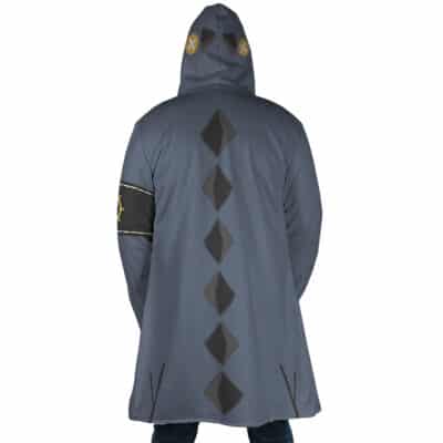 A person is seen from behind wearing the Jabber Wonger Cosplay Gachiakuta Dream Cloak Coat, a long gray hooded coat featuring black diamond shapes on the back and yellow circular designs on the hood and left arm.