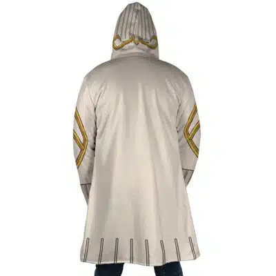 A person wears the Guita Hebby Fantasia Cosplay Gachiakuta Dream Cloak Coat (Copy), a light beige hooded cloak with gold and black geometric designs, shown from the back to reveal its knee-length cut and detailed hood.