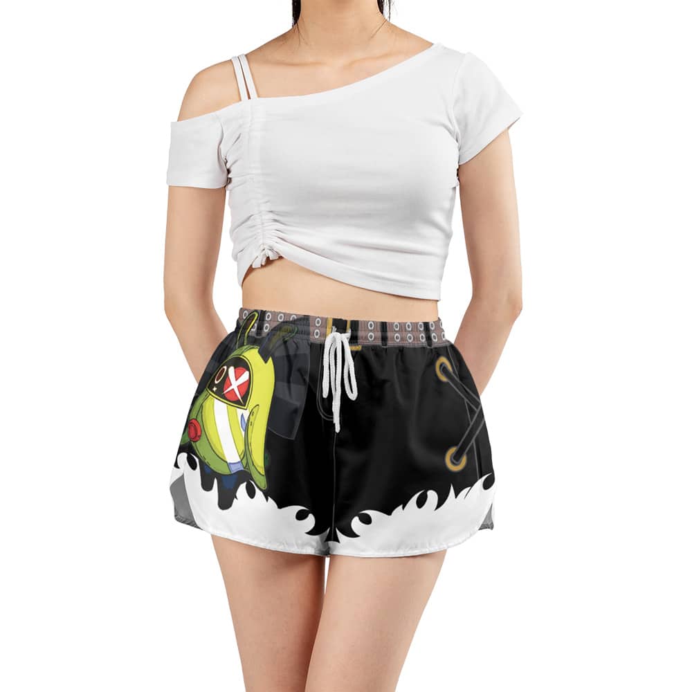 A woman wearing Zhu Yuan Pubsec Zenless Zone Zero Panties (Copy)—black shorts with a colorful cartoon design and white drawstring—paired with a white, off-shoulder crop top, stands with her hands in her pockets.