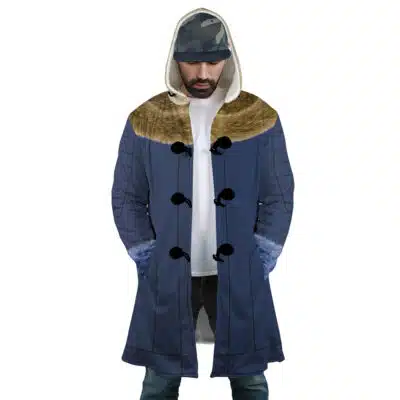 A man stands with hands in pockets, wearing the Kuzan Timeskip Cosplay One Piece Dream Cloak Coat—a blue trench coat with a fur-lined hood, furry blue cuffs, dark buttons—over a white shirt, blue jeans, and a camouflage-patterned cap.