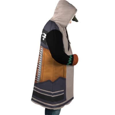 A person wearing the Hoshimi Miyabi Cosplay Zenless Zone Zero Dream Cloak Coat, featuring orange, black, gray, and beige geometric designs with black sleeves and green patterns, stands sideways with hands in the coat’s pockets.