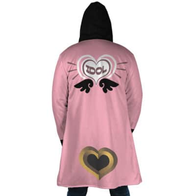 A person wearing the Belle Vibrant Store Manager Zenless Zone Zero Dream Cloak Coat—a long pink coat with a black hood, heart and "IDOL" graphic, black wings, and gold-black heart design on the back.