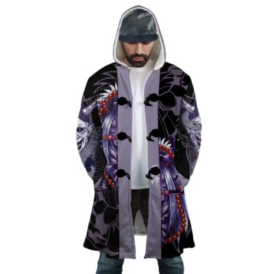 A man wears the Biggest Fan Bangboo Outfit Zenless Zone Zero Dream Cloak Coat, featuring masks, beads, and purple tones. The open hooded coat reveals a white shirt beneath. He looks down with hands in his pockets.
