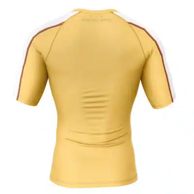 The Buff Anime Body Short Sleeve Rash Guard Compression Shirt features a yellow design with short sleeves, white and red stripes over the shoulders and down the sleeves, plus subtle text near the neck on the back.