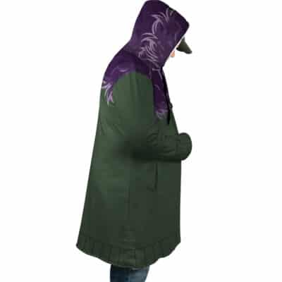 A person in profile wears the Shinigami Death Seal Shippuden Dream Cloak Coat with purple shoulder and hood designs, blue jeans, and a cap, standing against a white background.