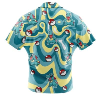 A short-sleeve Default Button Up Hawaiian Shirt with a blue and yellow wavy pattern, featuring Totodile Pokémon and Poké Balls printed all over the fabric.
