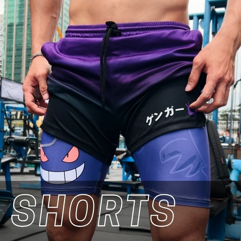Person wearing athletic shorts with a purple-to-black gradient, featuring a Gengar graphic on the left leg and Japanese text on the right leg.
